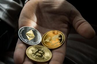 Hand holding Bitcoin, Ethereum, and Ripple coins representing digital currency.