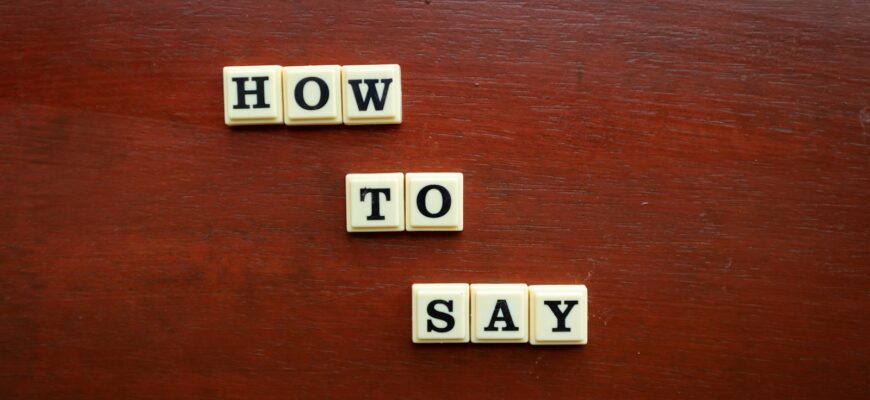 scrabble tiles spelling how to say on a wooden surface
