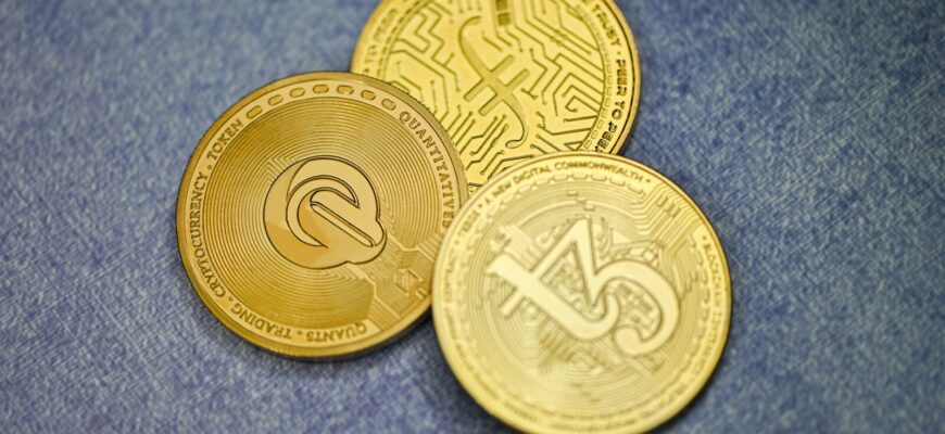 three gold coins sitting on top of a blue surface