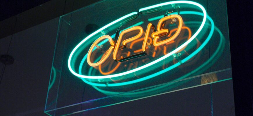 a neon sign hanging from the side of a building