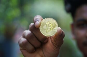 a man holding a bit coin in his hand
