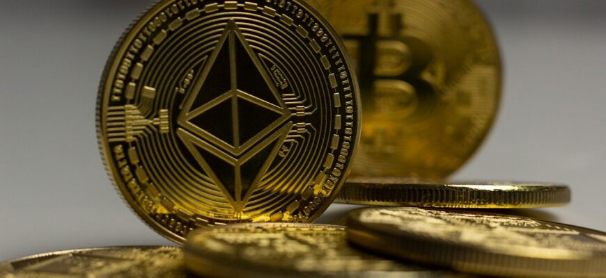 a pile of gold bitcoins sitting on top of a table