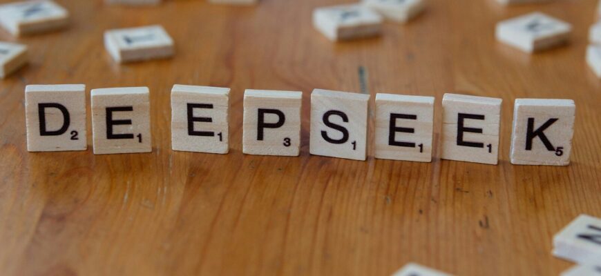 A wooden table topped with scrabble tiles spelling the word depeseek